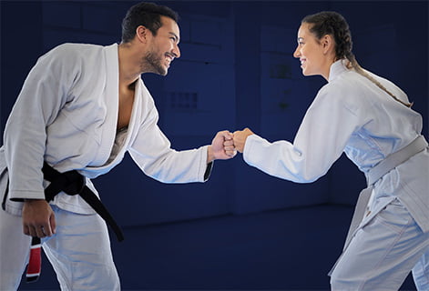 2 karate artists shaking hands in karate uniform